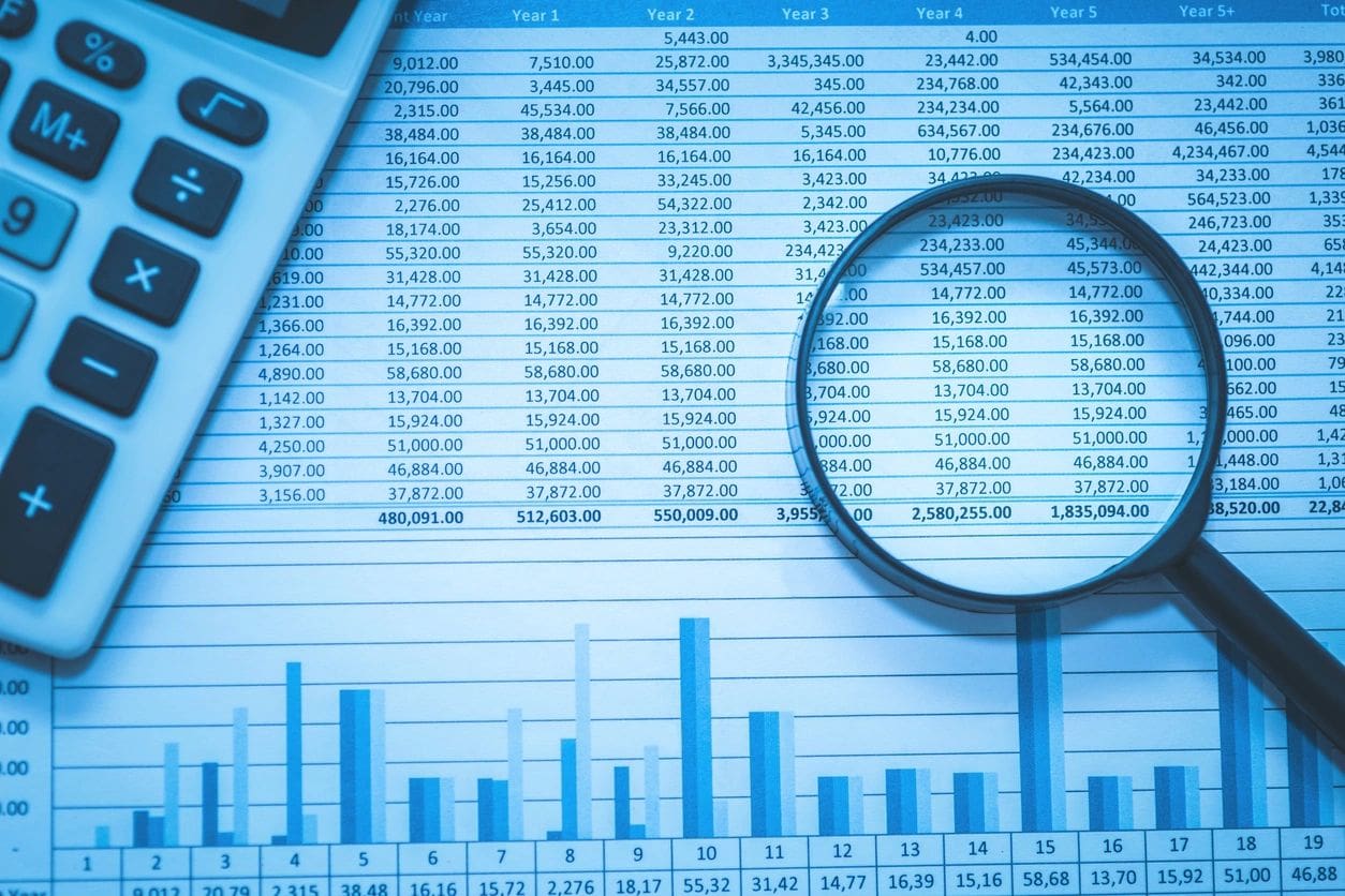 Financial data analysis with magnifying glass.