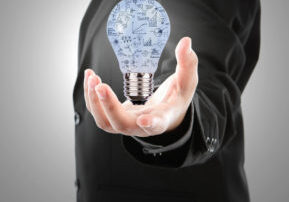 Business man holding light bulb with business concept  inside